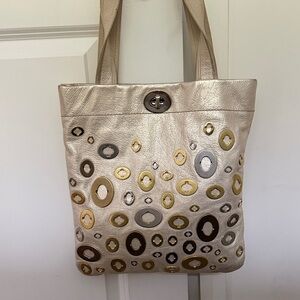 Coach Stylish Metallic Tote Bag with Circular Accents